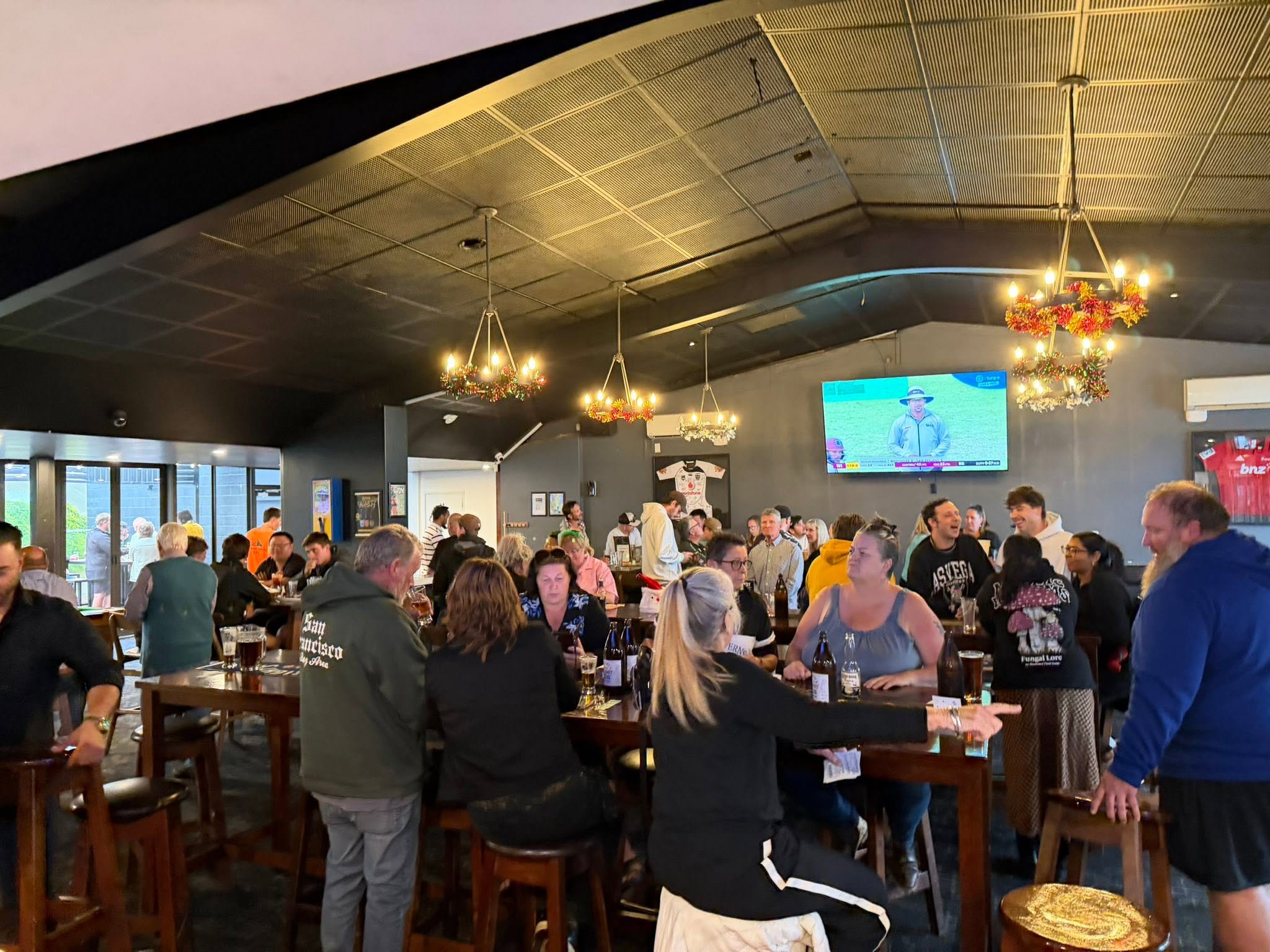 People enjoying a busy gathering inside The Riccs
