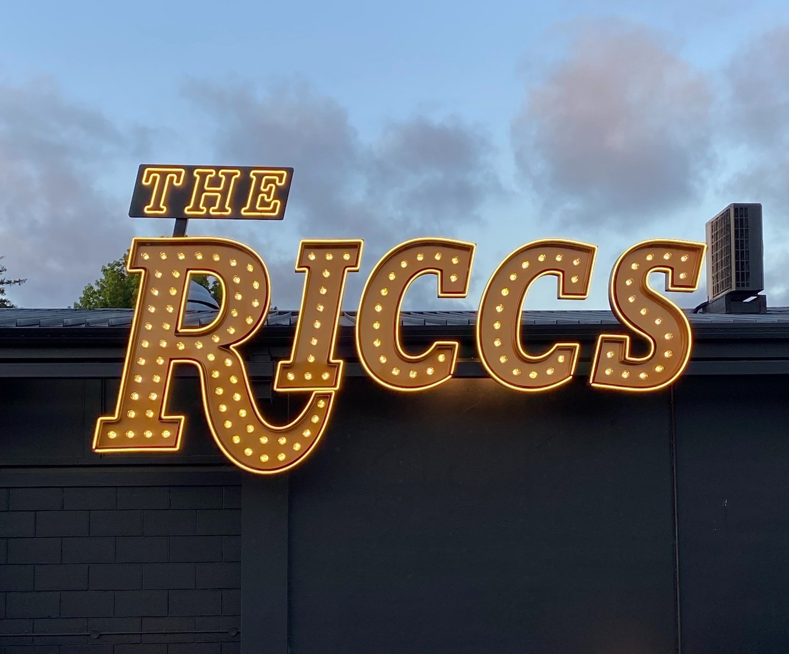 The illuminated Riccs sign outside the venue